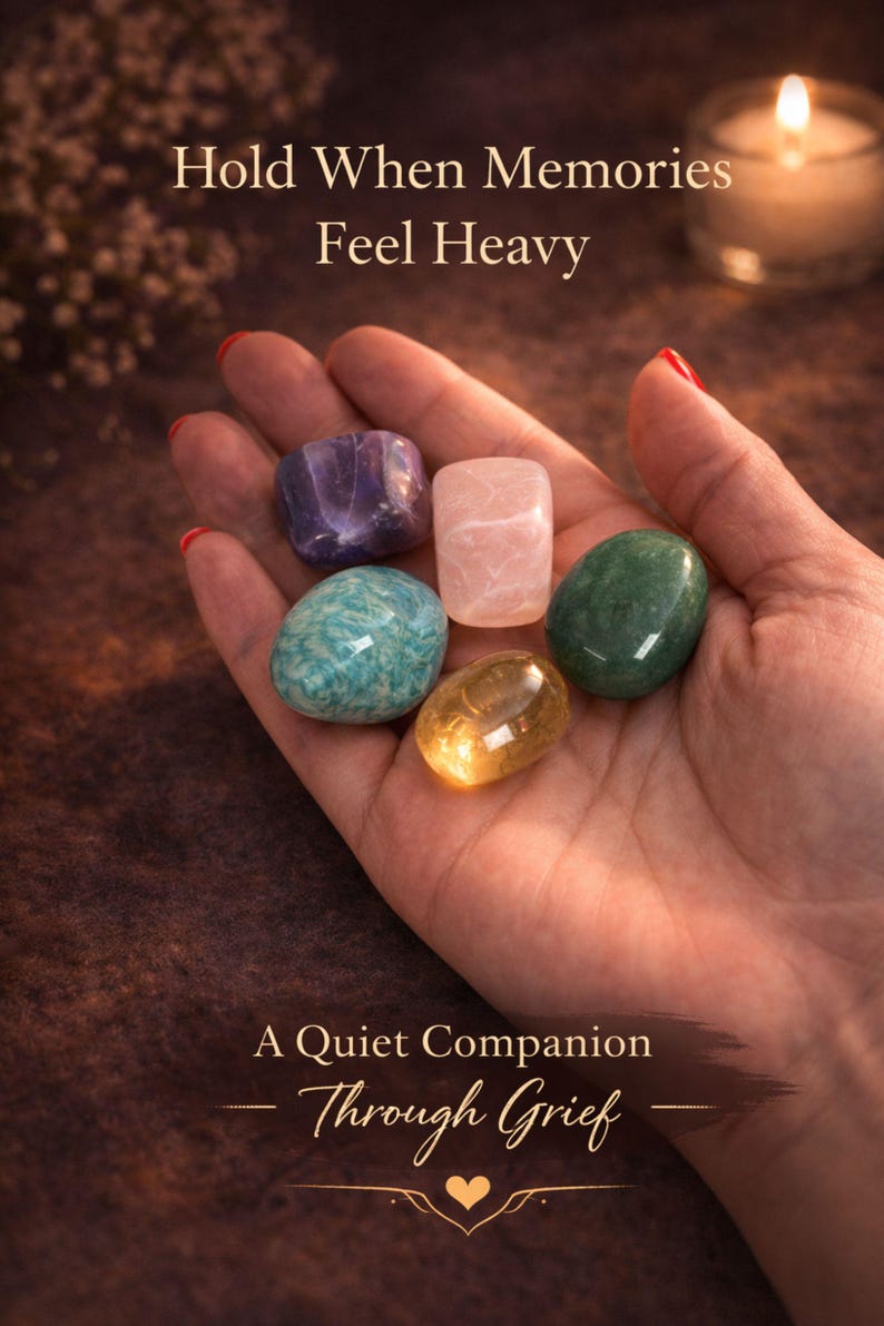 Grief support healing stones set informational cards from AuraBox displayed on a dark warm background with candlelight and dried flowers. The cards explain the meaning of Amethyst, Rose Quartz, Amazonite, Jade and Topaz crystals used for emotional healing, remembrance and comfort during loss. Memorial crystal gift set guide for sympathy, bereavement support and peaceful reflection.