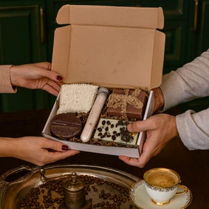 Coffee lover gift box featuring a handmade coffee scented candle and coffee inspired soap arranged in a cozy coffee themed gift box. This handmade coffee gift box is designed for coffee lovers and works as a unique coffee themed gift for birthdays, thank you gifts, or everyday gifting. A cozy coffee lover gift box ready to gift.