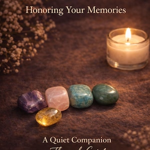 Grief support healing stones set informational cards from AuraBox displayed on a dark warm background with candlelight and dried flowers. The cards explain the meaning of Amethyst, Rose Quartz, Amazonite, Jade and Topaz crystals used for emotional healing, remembrance and comfort during loss. Memorial crystal gift set guide for sympathy, bereavement support and peaceful reflection.