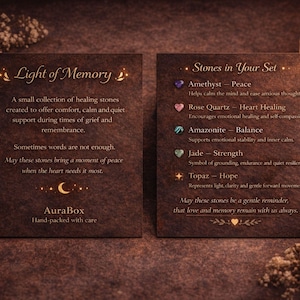 Grief support healing stones set informational cards from AuraBox displayed on a dark warm background with candlelight and dried flowers. The cards explain the meaning of Amethyst, Rose Quartz, Amazonite, Jade and Topaz crystals used for emotional healing, remembrance and comfort during loss. Memorial crystal gift set guide for sympathy, bereavement support and peaceful reflection.