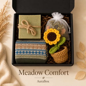 Fall gift box for women featuring a cozy autumn gift basket beautifully arranged in a premium black gift box with pumpkin accent, warm knit socks, sunflower detail, botanical candle, artisan soap and harvest-inspired gifts. Harvest Bliss Box is styled in rich orange, brown, golden yellow and cream fall colors, perfect as a Thanksgiving gift, hostess gift, fall birthday gift, pumpkin care package, autumn gift basket or cozy gift for her.