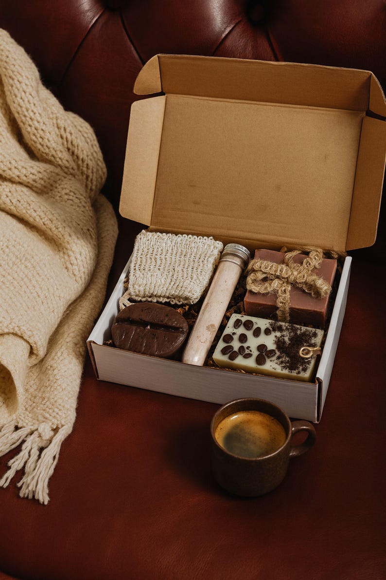 Coffee lover gift box featuring a handmade coffee scented candle and coffee inspired soap arranged in a cozy coffee themed gift box. This handmade coffee gift box is designed for coffee lovers and works as a unique coffee themed gift for birthdays, thank you gifts, or everyday gifting. A cozy coffee lover gift box ready to gift.
