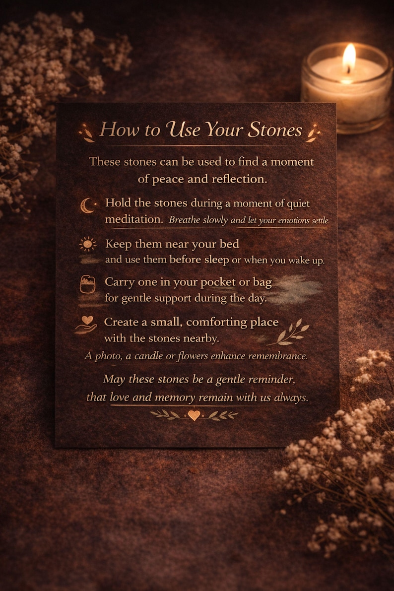 Grief support healing stones set informational cards from AuraBox displayed on a dark warm background with candlelight and dried flowers. The cards explain the meaning of Amethyst, Rose Quartz, Amazonite, Jade and Topaz crystals used for emotional healing, remembrance and comfort during loss. Memorial crystal gift set guide for sympathy, bereavement support and peaceful reflection.