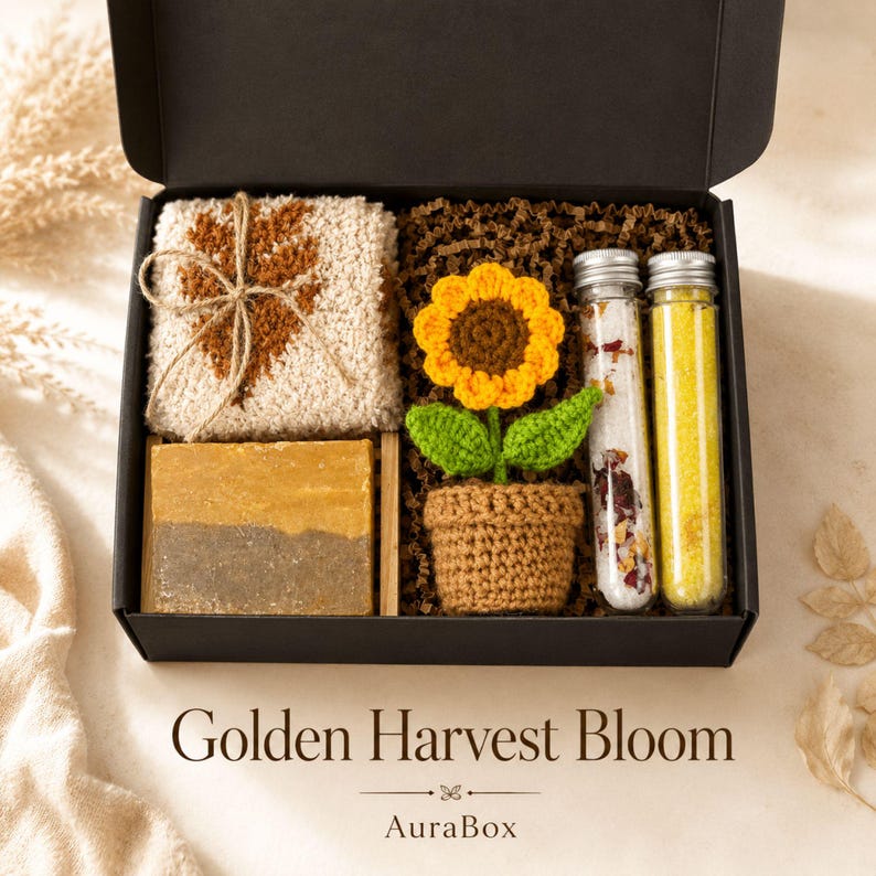 Fall gift box for women featuring a cozy autumn gift basket beautifully arranged in a premium black gift box with pumpkin accent, warm knit socks, sunflower detail, botanical candle, artisan soap and harvest-inspired gifts. Harvest Bliss Box is styled in rich orange, brown, golden yellow and cream fall colors, perfect as a Thanksgiving gift, hostess gift, fall birthday gift, pumpkin care package, autumn gift basket or cozy gift for her.