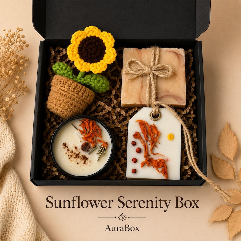 Fall gift box for women featuring a cozy autumn gift basket beautifully arranged in a premium black gift box with pumpkin accent, warm knit socks, sunflower detail, botanical candle, artisan soap and harvest-inspired gifts. Harvest Bliss Box is styled in rich orange, brown, golden yellow and cream fall colors, perfect as a Thanksgiving gift, hostess gift, fall birthday gift, pumpkin care package, autumn gift basket or cozy gift for her.