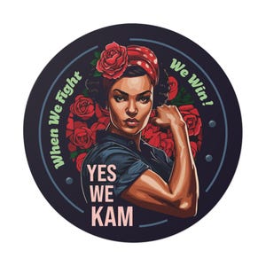 May include: A round sticker with a dark blue background and a white circle in the center. The circle features a woman with dark hair and brown skin, wearing a red bandana and a blue shirt. She is flexing her bicep with a red rose behind her arm. The text "When We Fight" is on the left side of the circle, and "We Win!" is on the right side. The text "YES WE KAM" is in the center of the circle.