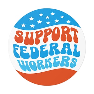 May include: A white circle sticker with a red, white, and blue American flag design. The text "SUPPORT FEDERAL WORKERS" is written in a retro, wavy font.