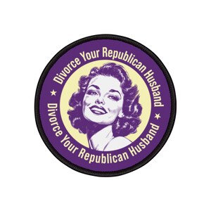 May include: A round patch with a black border and the text "Divorce Your Republican Husband" in purple. The patch features a vintage illustration of a woman with purple hair and a yellow background.