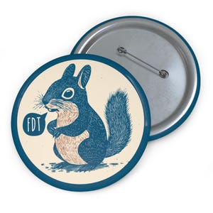 May include: A blue and white button featuring a cartoon squirrel saying "FDT" in a speech bubble. The squirrel is drawn in a vintage style.