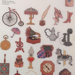 May include: A cross-stitch pattern sheet titled "Mini Motif Designs Attic Antiques." The sheet features various antique-themed designs, including a bicycle, lamp, inkwell, hat, boot, umbrella, pocket watch, gramophone, teapot, and clock.