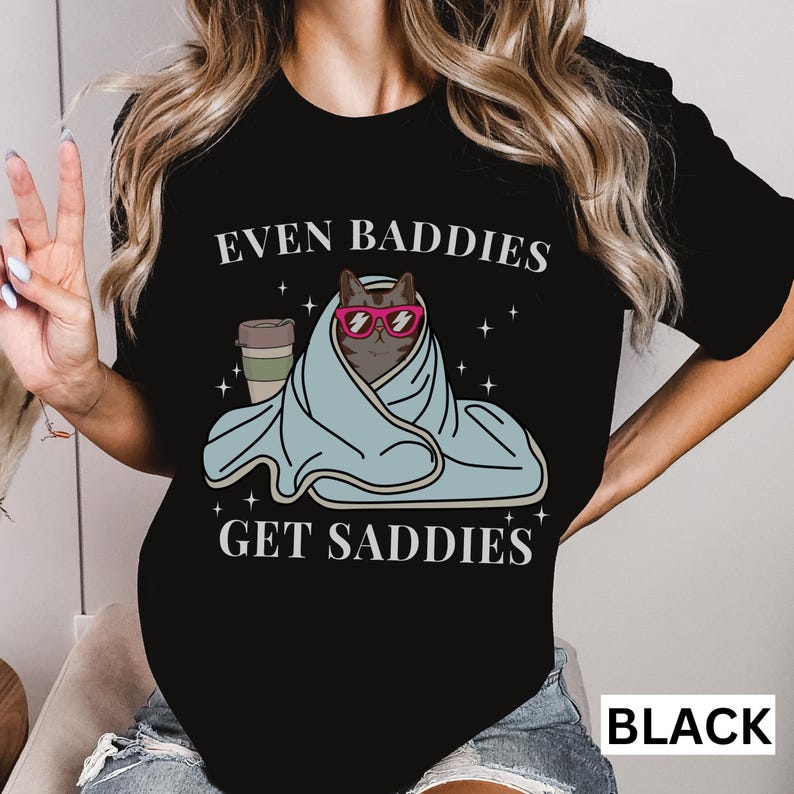 a woman wearing a t - shirt that says even baddies get saddles