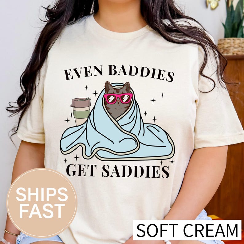 a woman wearing a t - shirt that says even baddies get saddles