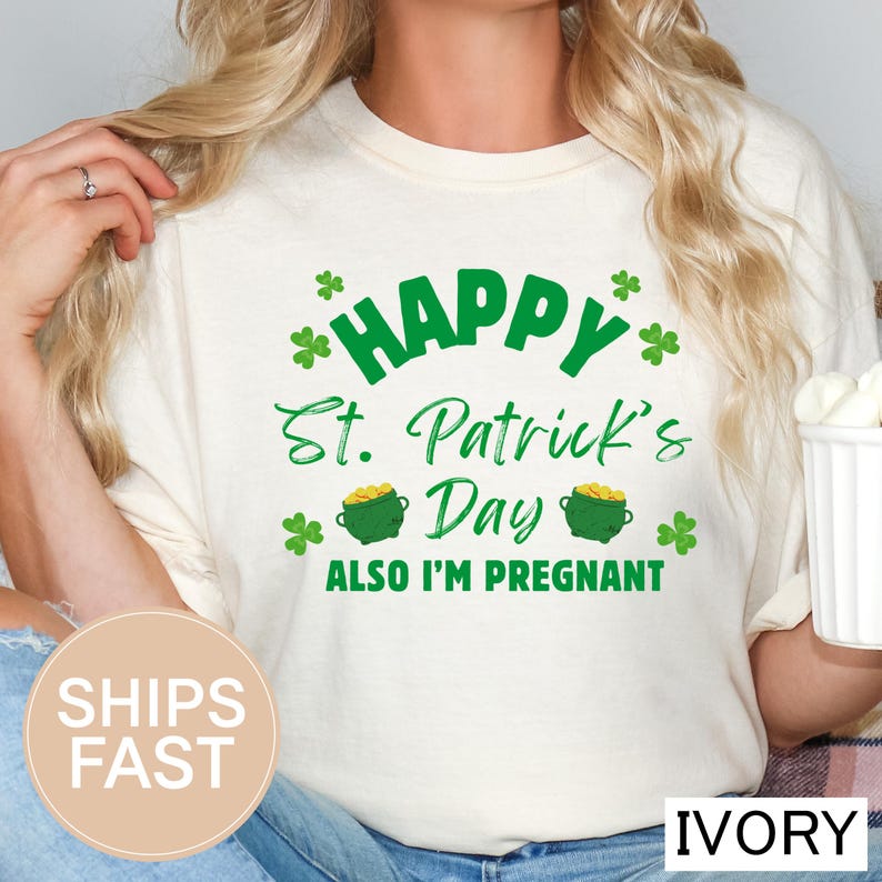 A woman wearing a white t-shirt with a humorous text and graphics related to St. Patrick's Day and pregnancy.