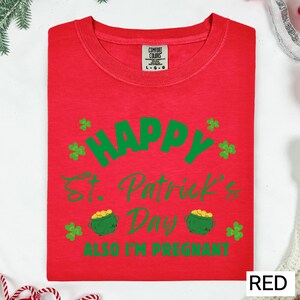 A red t-shirt with a humorous text and graphics related to St. Patrick's Day and pregnancy.