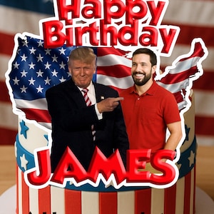 May include: A birthday cake with an American flag design, featuring the words "Happy Birthday" and "JAMES" in red. The cake has a photo of two men. The text "Add your own photo" is also visible.