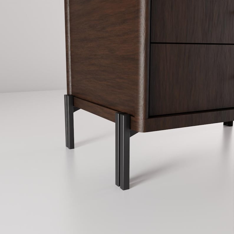May include: A dark brown wooden cabinet with two drawers and black metal legs. The cabinet has a smooth, polished finish and a modern design. The legs are rectangular and provide a sturdy base.