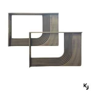 May include: Two metal table legs with a geometric design. The legs are made of a dark metal with a brushed finish. The legs are shaped like an L, with the top of the L being curved.