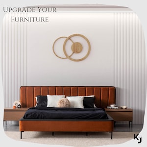 May include: A brown upholstered bed frame with a black mattress and a headboard with vertical panels. The bed is in a bedroom with a white wall and a wooden wall decor. The text "UPGRADE YOUR FURNITURE" is at the top of the image.
