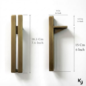 May include: Two bronze-colored cabinet pulls. One pull is 7.4 inches tall and 6 inches long, the other is 7.4 inches tall. The pulls are 2.4 inches wide and 1.4 inches deep. The pulls have a rectangular design.