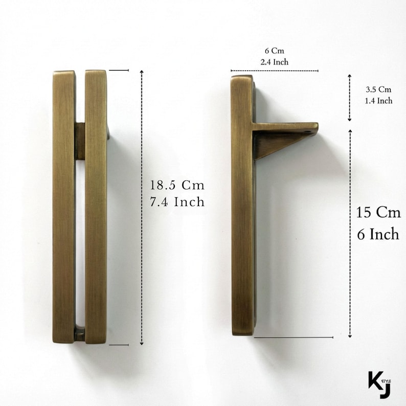 May include: Two bronze-colored cabinet pulls. One pull is 7.4 inches tall and 6 inches long, the other is 7.4 inches tall. The pulls are 2.4 inches wide and 1.4 inches deep. The pulls have a rectangular design.