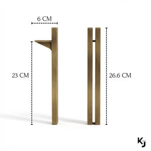 May include: Two bronze-colored cabinet pulls. One pull is 9 inches tall and 2.4 inches wide, with a small shelf. The other pull is 10.5 inches tall. The pulls are made of metal and have a modern design.