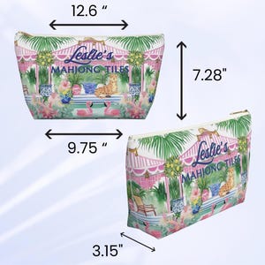 A tropical print preppy Palm Beach style personalized Mahjong tile bag shown from two angles with size measurements marked. The personalizable custom bag design includes flamingos, greenery, and a cheetah under a striped canopy.