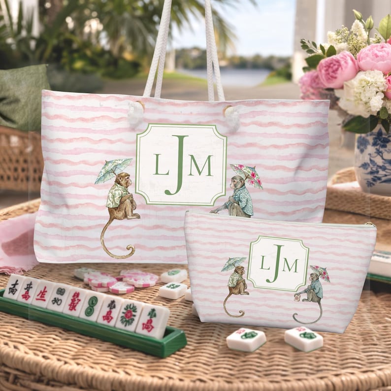 Pink and Green Monkey Mahjong Tote Bag and Tile Pouch Set on a white bamboo table, Palm Beach style