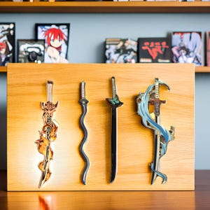 May include: Four decorative sword pins with intricate designs. The swords are gold, black, and silver with blue and green accents. The pins are displayed on a wooden board.