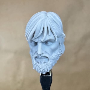 May include: A 3D printed head sculpt of a man with a beard and short hair. The sculpt is unpainted and shows detail in the facial features and hair.