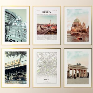May include: Six framed art prints with gold frames. The prints feature images of Berlin, Germany, including architectural structures, cityscapes, and a map. The prints are displayed against a neutral background.