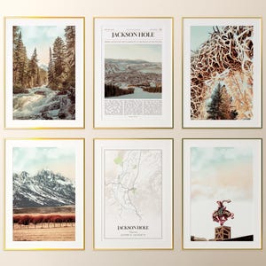 May include: Six framed art prints with gold frames. The prints feature landscape scenes, including a waterfall, mountain range, and a map. One print has the text "JACKSON HOLE". Another print shows a sign that says "WELCOME".