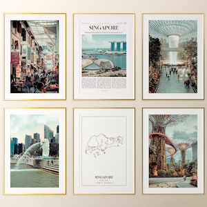 May include: Six framed art prints with gold borders. The prints feature images of Singapore, including cityscapes, gardens, and a map. The prints are displayed against a neutral background.