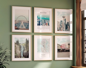 May include: Six framed art prints with gold frames hang on a green wall. The prints depict scenes of Seattle, including the Space Needle, a Ferris wheel, a map, a waterfall, and Pike Place Market.