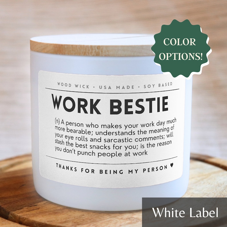 May include: White candle with a wooden lid and a white label that reads "Work Bestie (n) A person who makes your work day much more bearable; understands the meaning of your eye rolls and sarcastic comments; will stash the best snacks for you; is the reason you don't punch people at work Thanks for being my person".