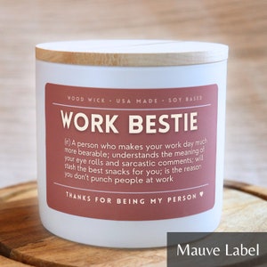 May include: White candle with a wooden lid and a mauve label that reads "Work Bestie" with a definition of the term and the phrase "Thanks for being my person".