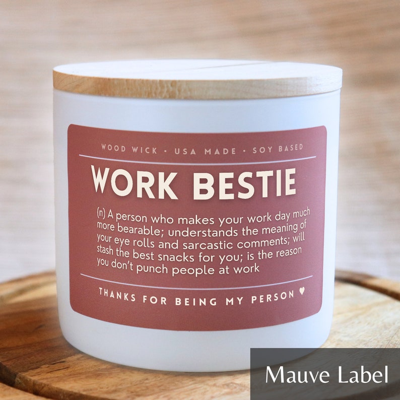 May include: White candle with a wooden lid and a mauve label that reads "Work Bestie" with a definition of the term and the phrase "Thanks for being my person".