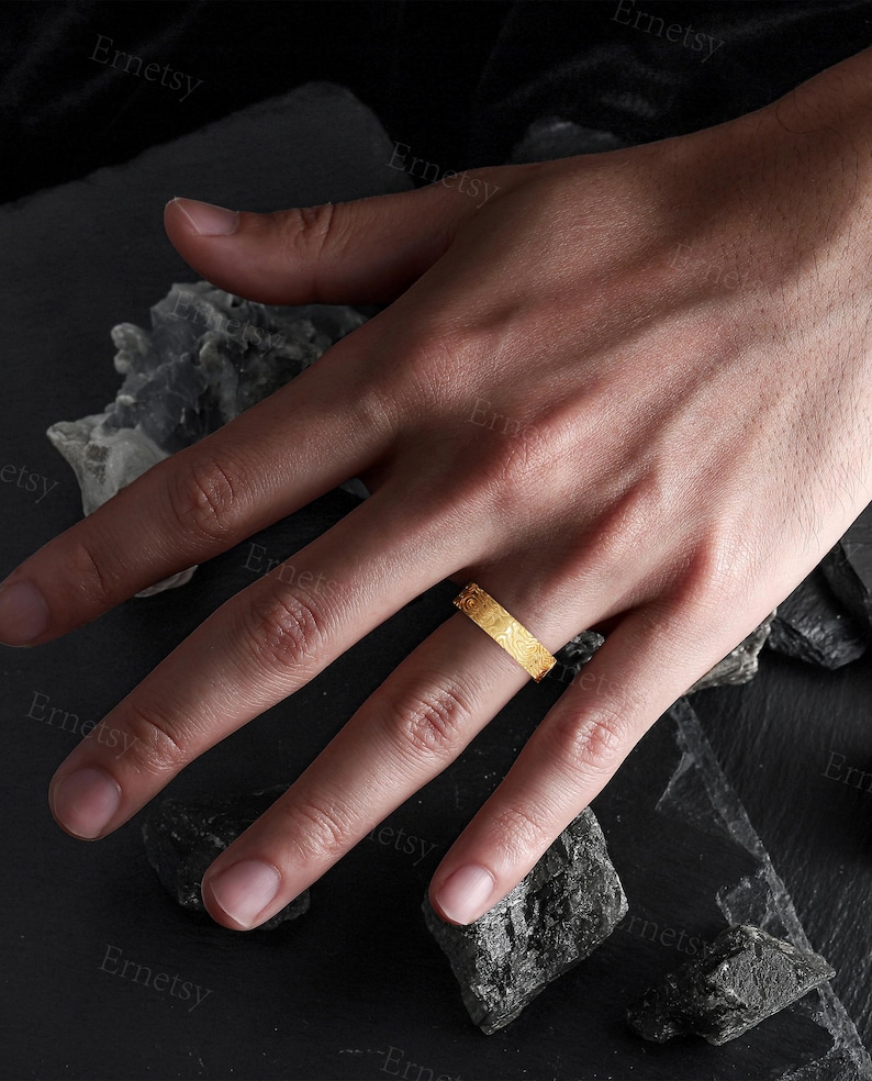 a person's hand with a ring on it
