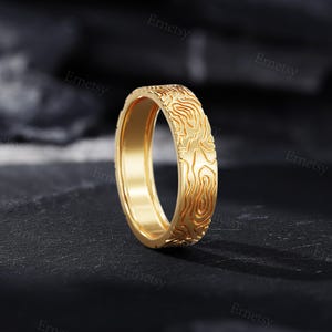 a gold ring with a design on it