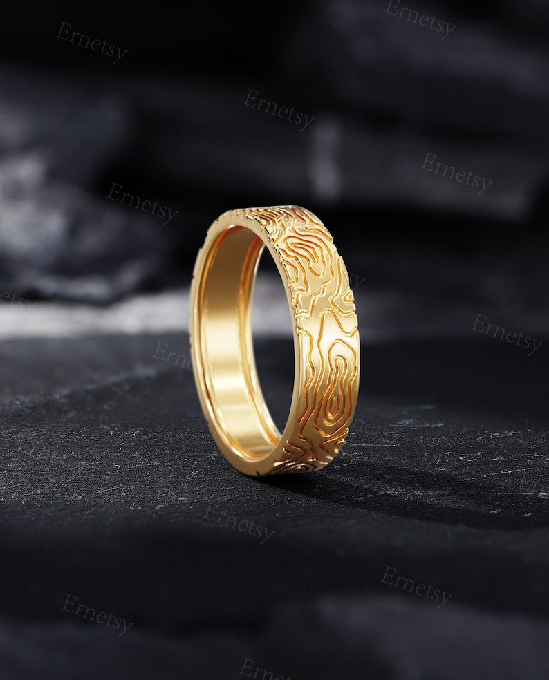 a gold ring with a design on it