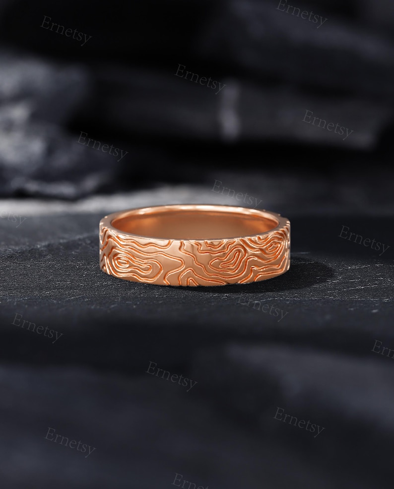 a wedding band with a carved design on it