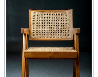 May include: Wooden chair with a woven cane back and seat. The chair has a natural wood finish and a rectangular back. The arms are short and square. The chair is a classic design.