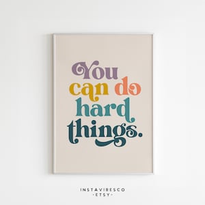 May include: A motivational poster with a beige background and the text "You can do hard things." in a colorful retro font.