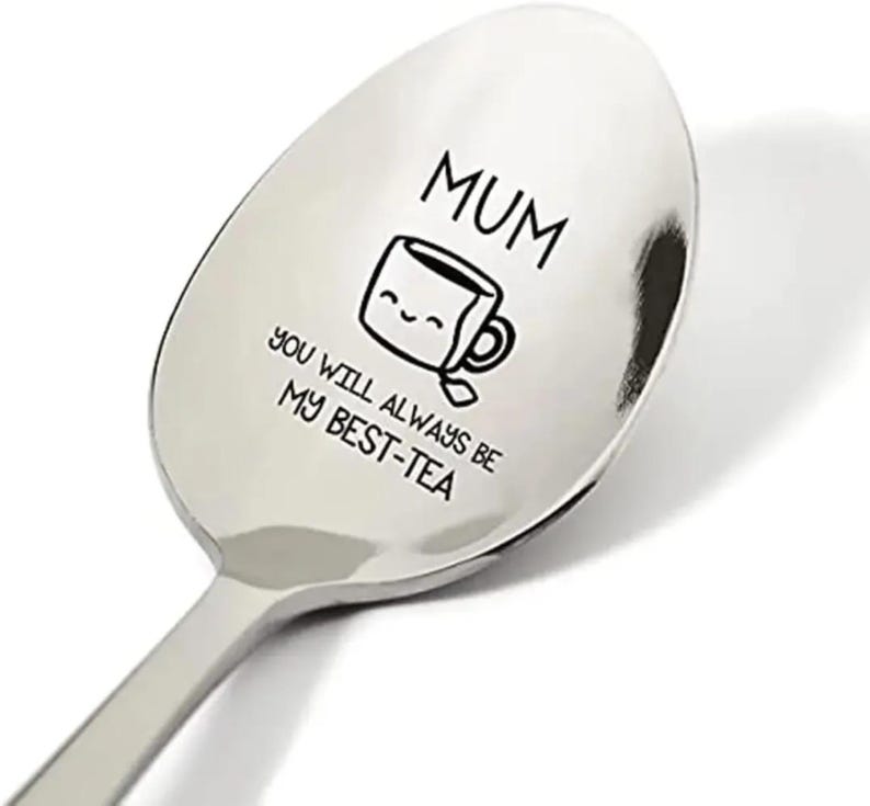 May include: A stainless steel spoon with the text "MUM you will always be my best-tea" engraved on it. The text is accompanied by a cartoon image of a teacup with a smiling face.