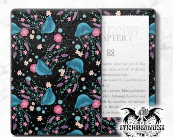 May include: Black e-reader cover featuring a pattern of blue jellyfish, pink flowers, and lavender sprigs. The design includes small white stars and light blue bubbles. The e-reader displays text from a book.