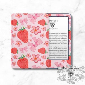 May include: A pink e-reader cover featuring a design of red strawberries, pink bows, and flowers. The e-reader is open, displaying text from "Chapter 1". The cover has the text "Sticky Sadness Designs".