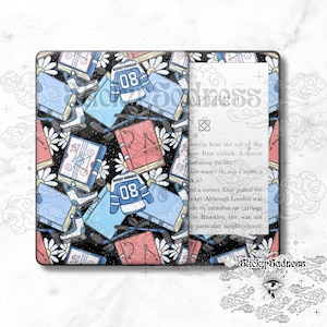 May include: A Kindle Paperwhite e-reader with a custom cover featuring a black background with a repeating pattern of blue and pink books, hockey jerseys, and white daisies. The text "Sticky Sadness" is visible on the bottom right corner of the cover.