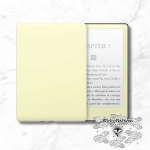 May include: A yellow Kindle e-reader with a black cover. The screen displays the text "APTER 1" and a short excerpt from a book.