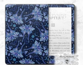 May include: A dark blue Kindle Paperwhite e-reader cover featuring a repeating pattern of blue and white moths, stars, and crescent moons. The text "Chapter 1" is visible on the right side of the cover.