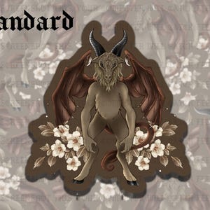 May include: A sticker featuring a mythical creature with goat-like features, including horns and a furry body, and large brown wings. The creature is surrounded by white flowers and the word "Standard" is at the top in a gothic font.
