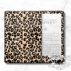 May include: A black and white Kindle e-reader with a leopard print skin. The screen shows the text "Chapter 1" and a passage from a book.